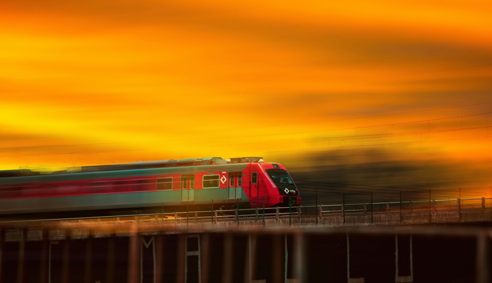 red and white train on rail during sunset